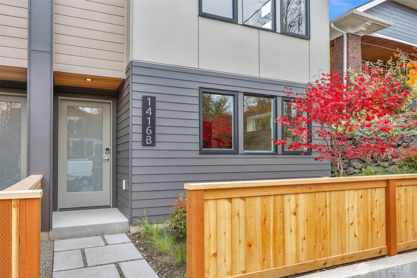 1416 North 47th Street, Unit B Seattle, WA 98103 - Photo 25 of 33 a view of a brick house with potted plants