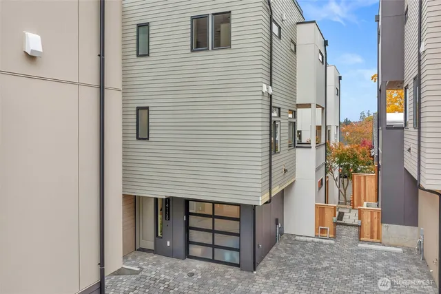 a view of a house with a door and wooden walls