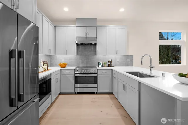 a kitchen with a sink stove and refrigerator