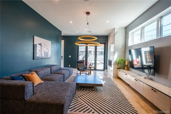 a living room with furniture a flat screen tv and a fireplace