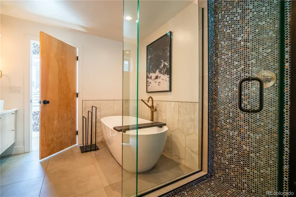a bathroom with a tub and shower