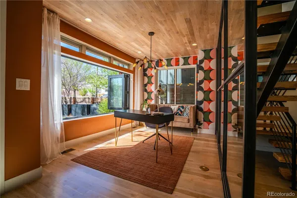 a living room with large windows and a table