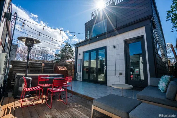 a kitchen with stainless steel appliances granite countertop a refrigerator a stove a sink dishwasher a dining table and chairs with wooden floor