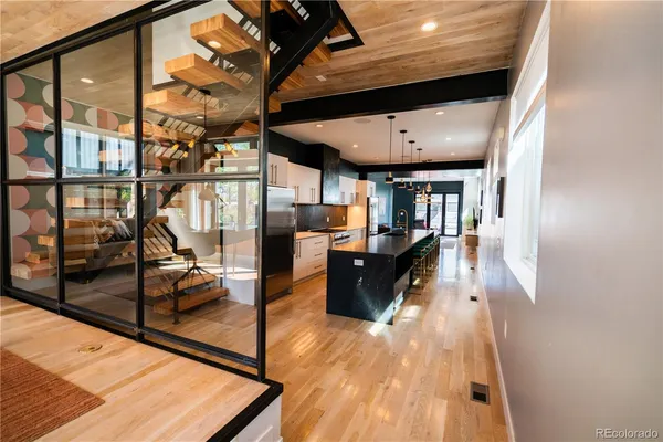 a kitchen with stainless steel appliances kitchen island granite countertop a stove a sink and a microwave