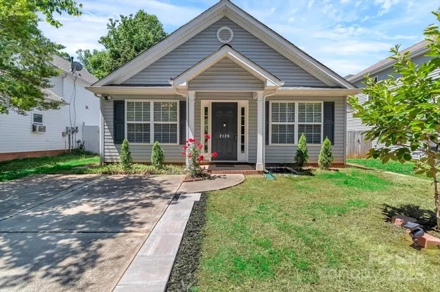 a front view of a house with a yard table and chairs