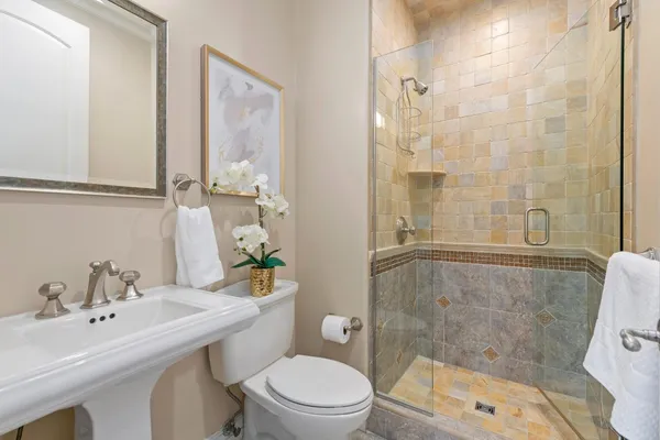 a bathroom with a sink toilet and shower
