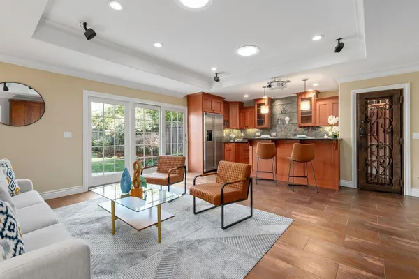 a living room with furniture and a kitchen area