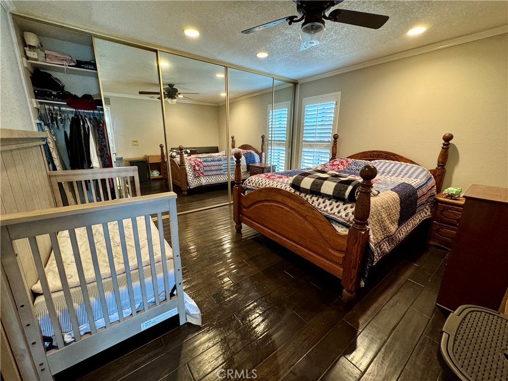 6312 Marina Pacifica Drive Long Beach, CA 90803 - Photo 11 of 30 a spacious bedroom with a bed and a chandelier