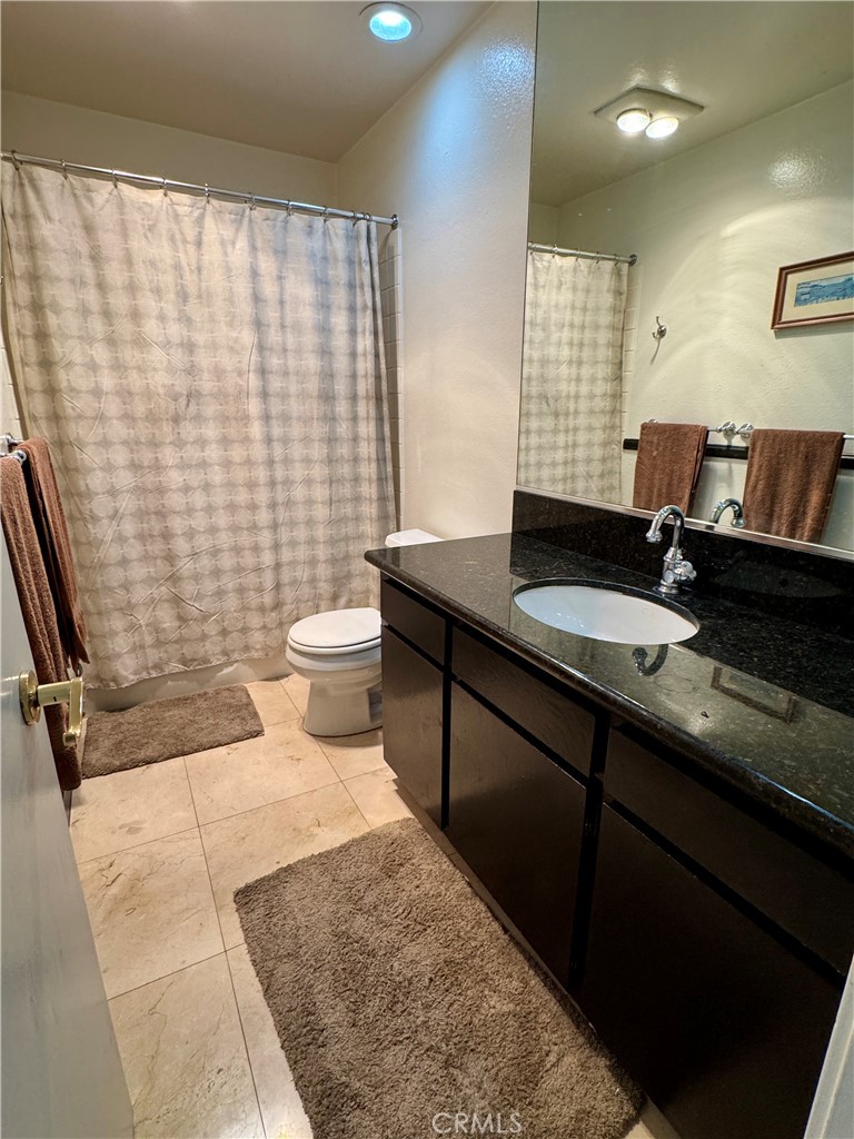 6312 Marina Pacifica Drive Long Beach, CA 90803 - Photo 12 of 30 a bathroom with a double vanity sink toilet and a shower