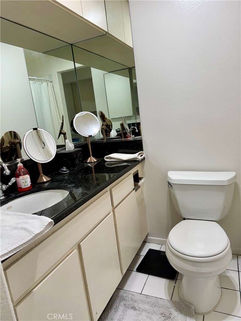 6312 Marina Pacifica Drive Long Beach, CA 90803 - Photo 20 of 30 a bathroom with a toilet a sink and a mirror