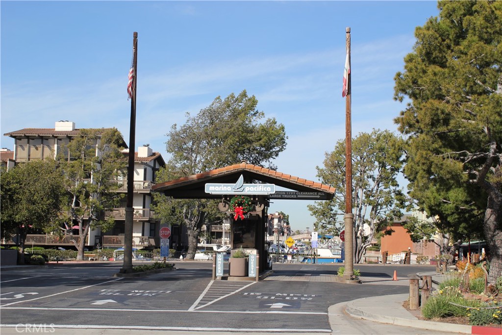 6312 Marina Pacifica Drive Long Beach, CA 90803 - Photo 23 of 30 a street sign on a sidewalk next to a road