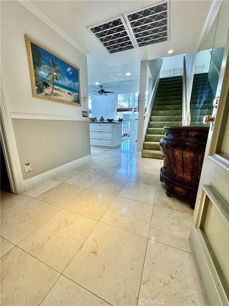6312 Marina Pacifica Drive Long Beach, CA 90803 - Photo 3 of 30 a view of an empty room and staircase with kitchen view