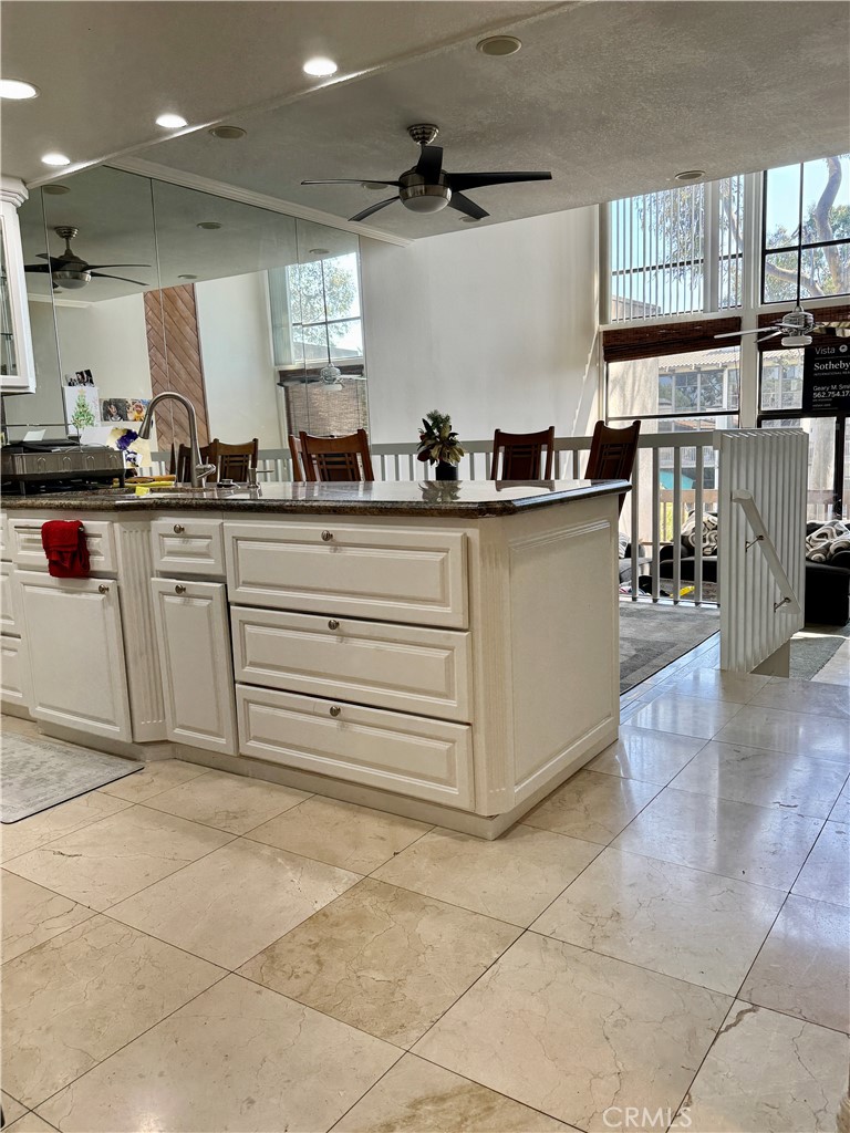6312 Marina Pacifica Drive Long Beach, CA 90803 - Photo 4 of 30 a kitchen with stainless steel appliances granite countertop a sink and cabinets