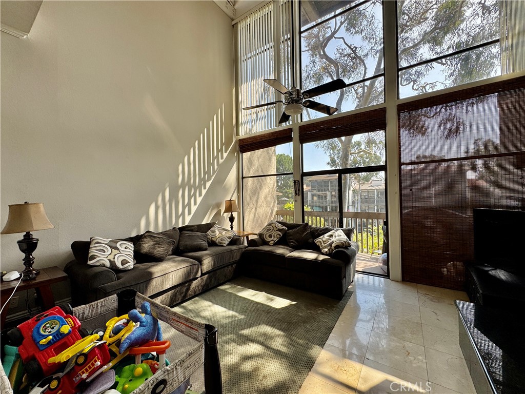 6312 Marina Pacifica Drive Long Beach, CA 90803 - Photo 10 of 30 a living room with furniture and a floor to ceiling window