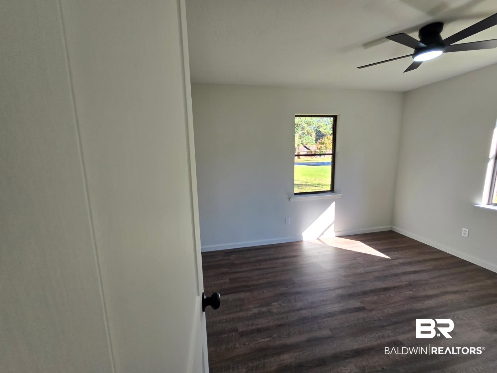 1404 Dailey Street Brewton, AL 36426 - Photo 16 of 25 Spare room featuring dark wood-type flooring and ceiling fan