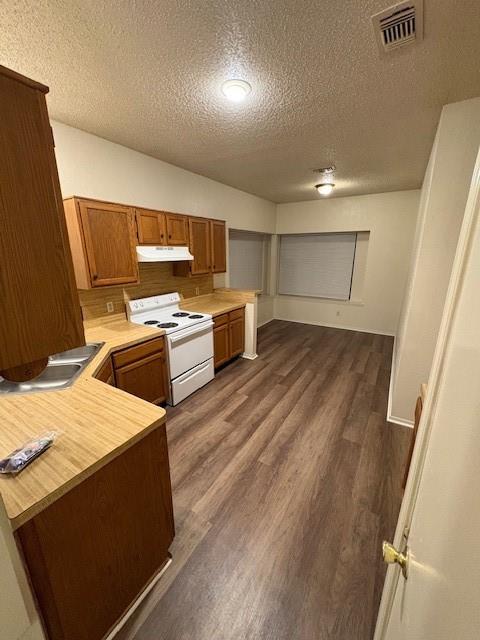 7814 Estates Way Rowlett, TX 75089 - Photo 3 of 9 a large kitchen with a wooden floor and stainless steel appliances