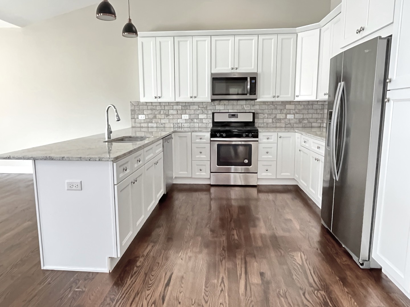 855 Meadow Lane Marengo, IL 60152 - Photo 5 of 22 a kitchen with a sink a refrigerator and a stove