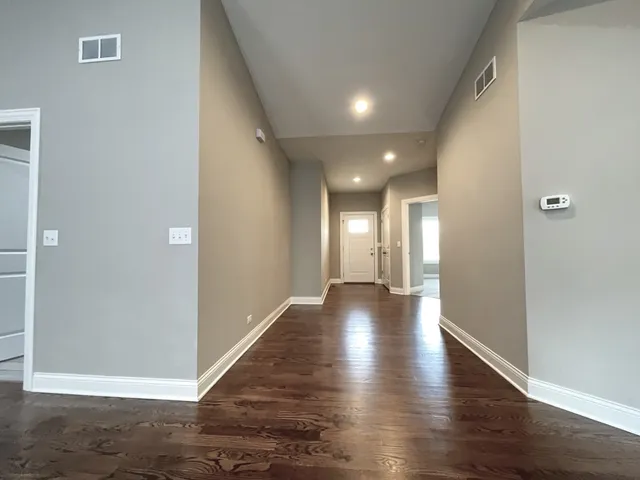 a view of gallery with wooden floor