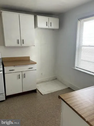 a utility room with cabinets washer and dryer