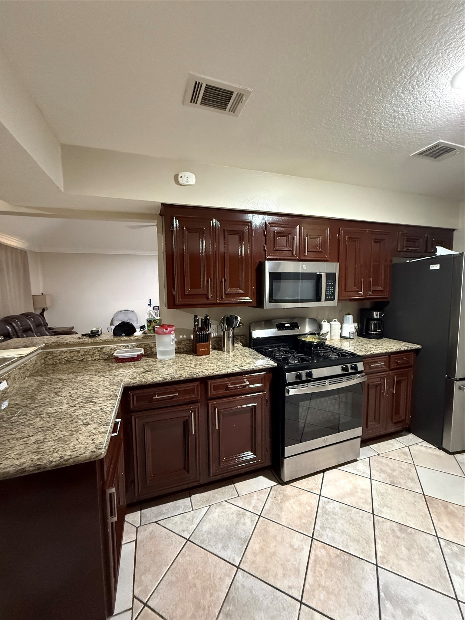 3103 Pine Dust Lane Spring, TX 77373 - Photo 20 of 29 a kitchen with stainless steel appliances granite countertop a stove granite counter tops and white cabinets