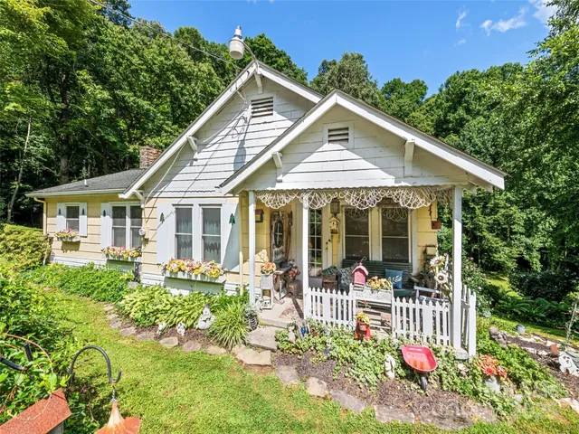 a front view of a house with a yard table and chairs