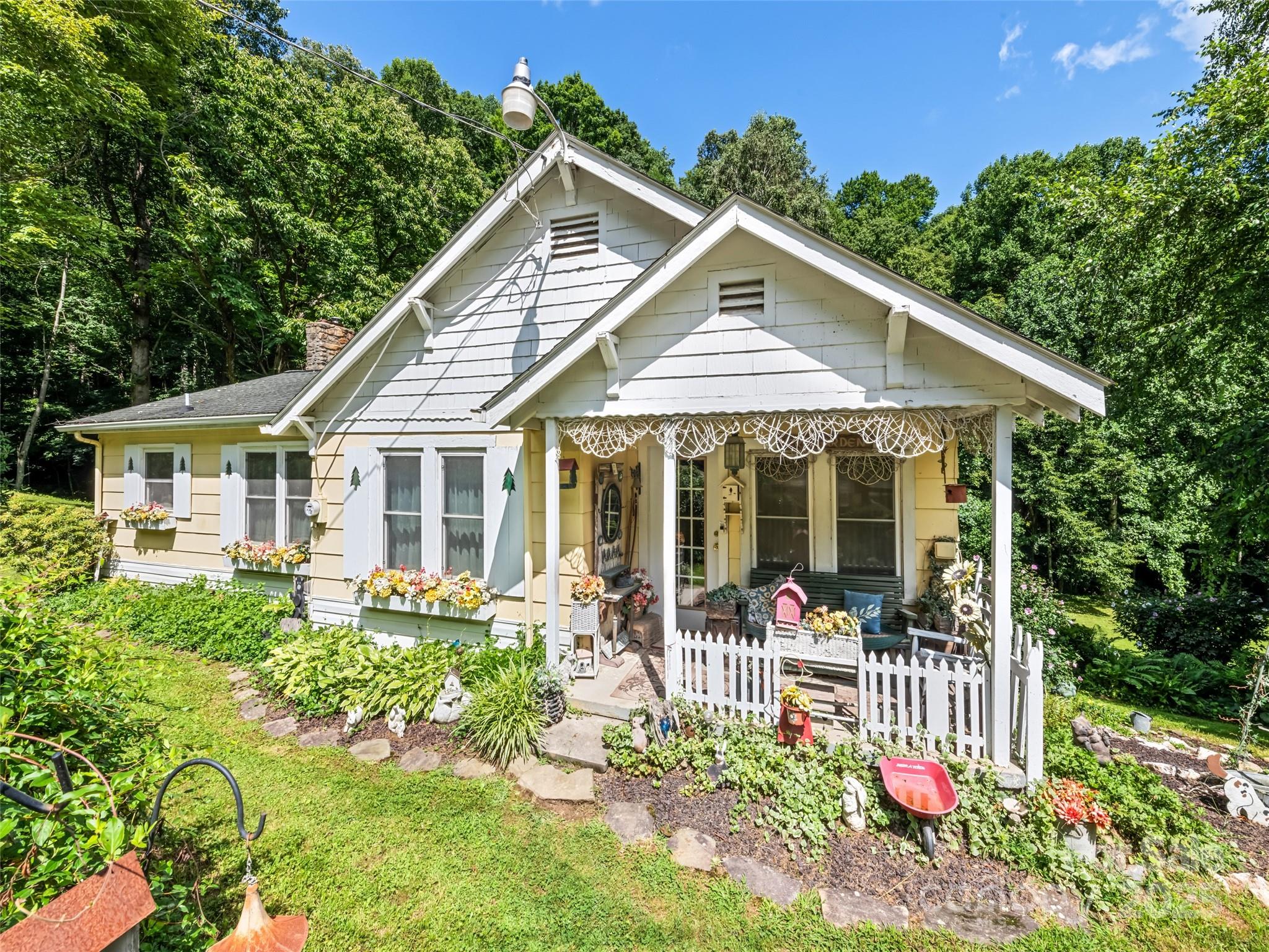 a front view of a house with a yard table and chairs