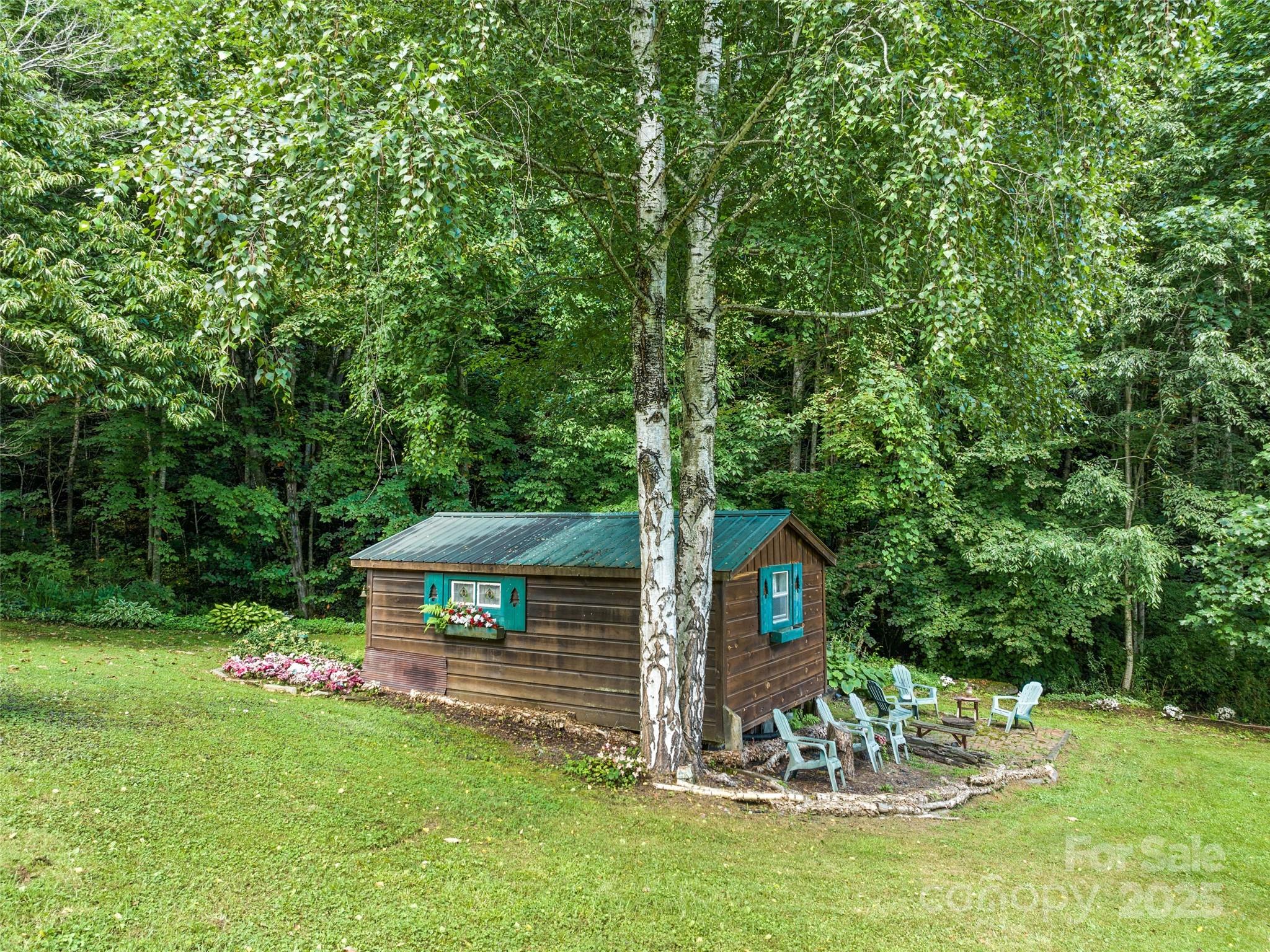 4828 Max Patch Road Clyde, NC 28721 - Photo 16 of 41 a view of a table and chairs in the garden