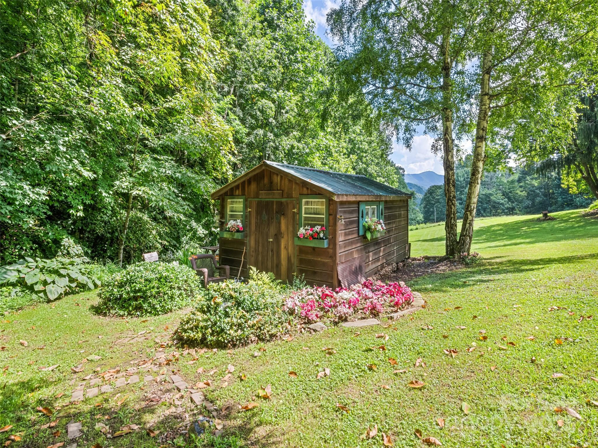 4828 Max Patch Road Clyde, NC 28721 - Photo 17 of 41 a front view of a house with garden