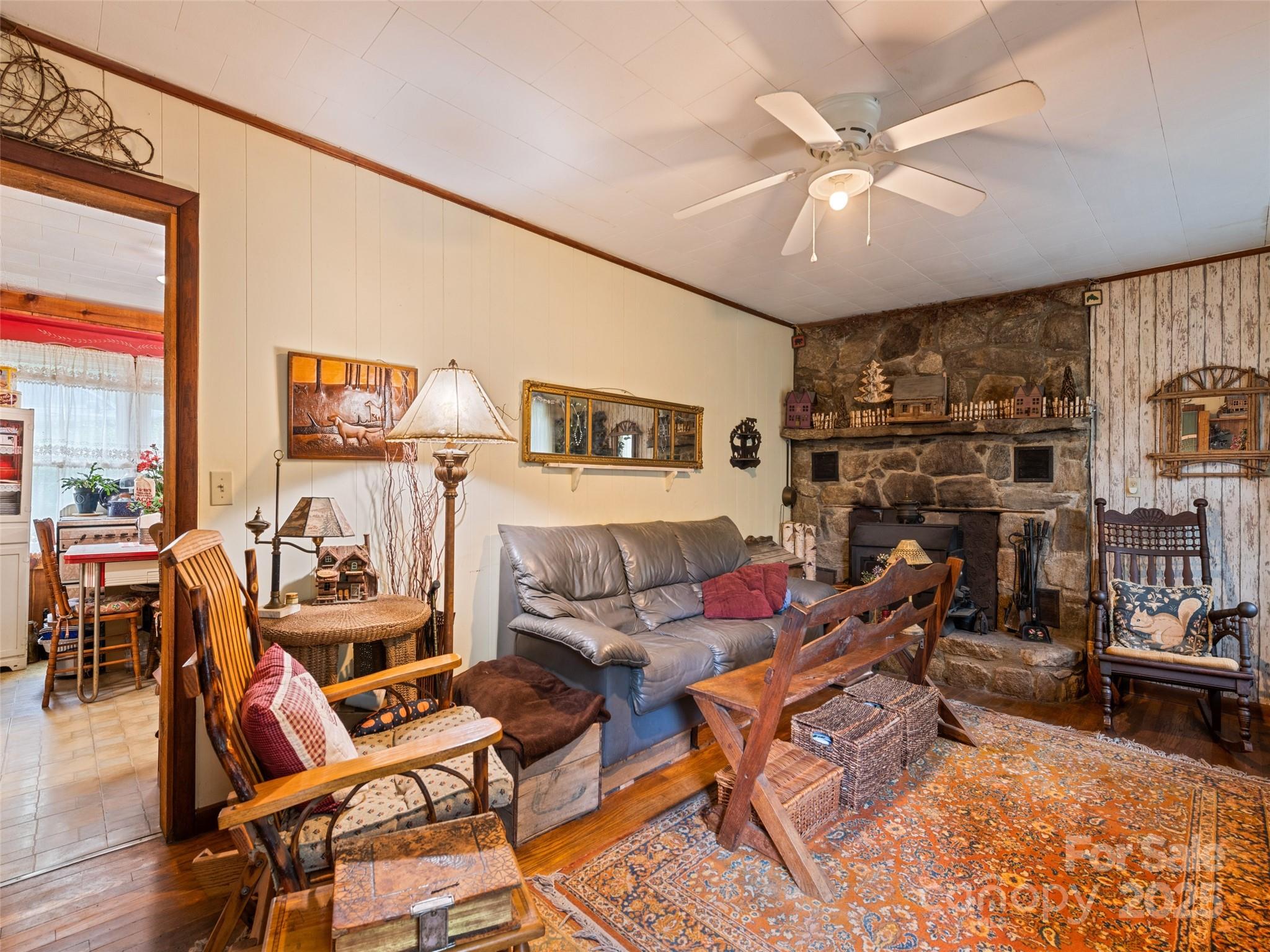 4828 Max Patch Road Clyde, NC 28721 - Photo 29 of 41 a living room with furniture and a floor to ceiling window