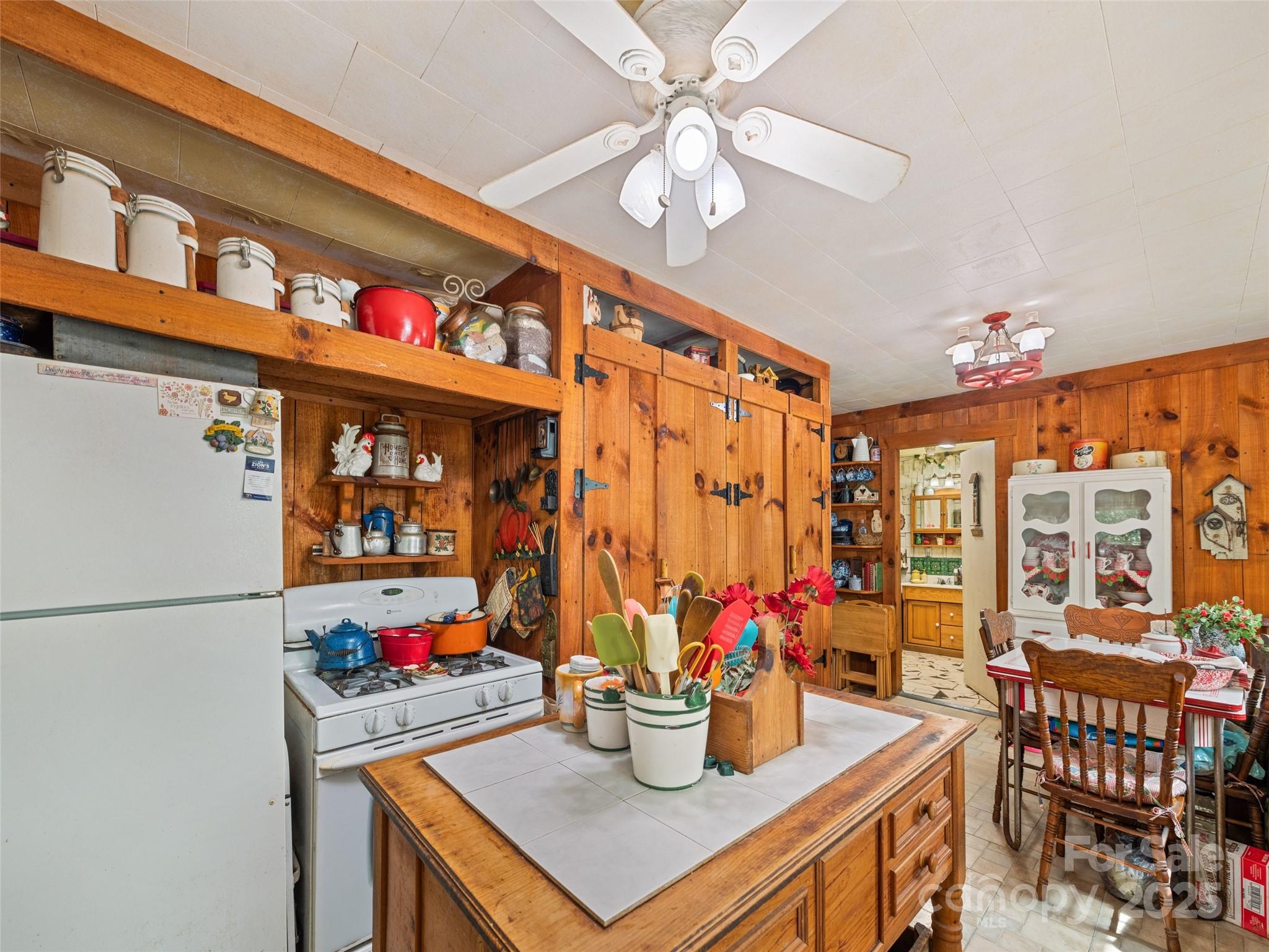 4828 Max Patch Road Clyde, NC 28721 - Photo 33 of 41 a kitchen with a dining table and chairs