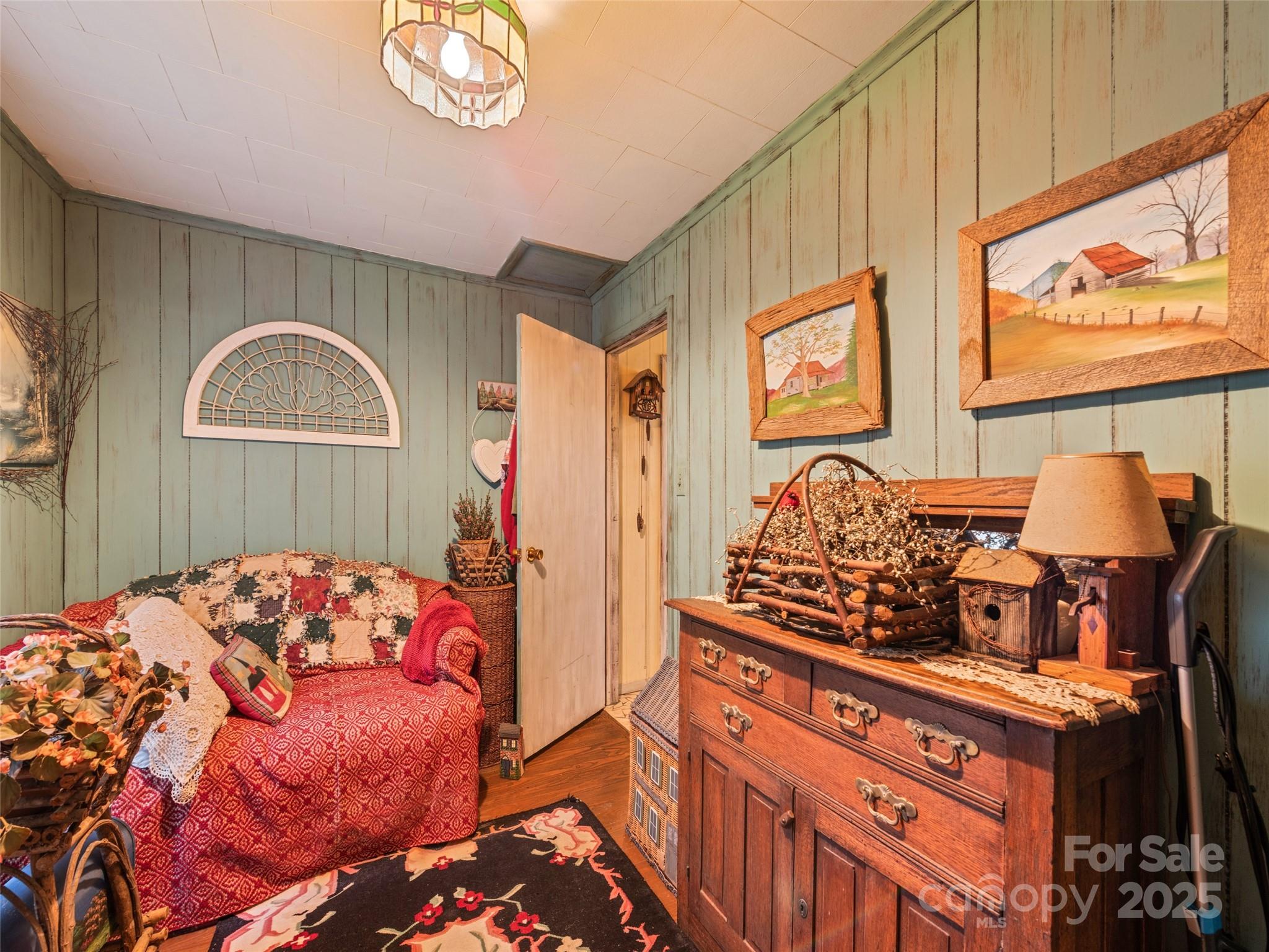 4828 Max Patch Road Clyde, NC 28721 - Photo 36 of 41 a bedroom with a bed and a chandelier