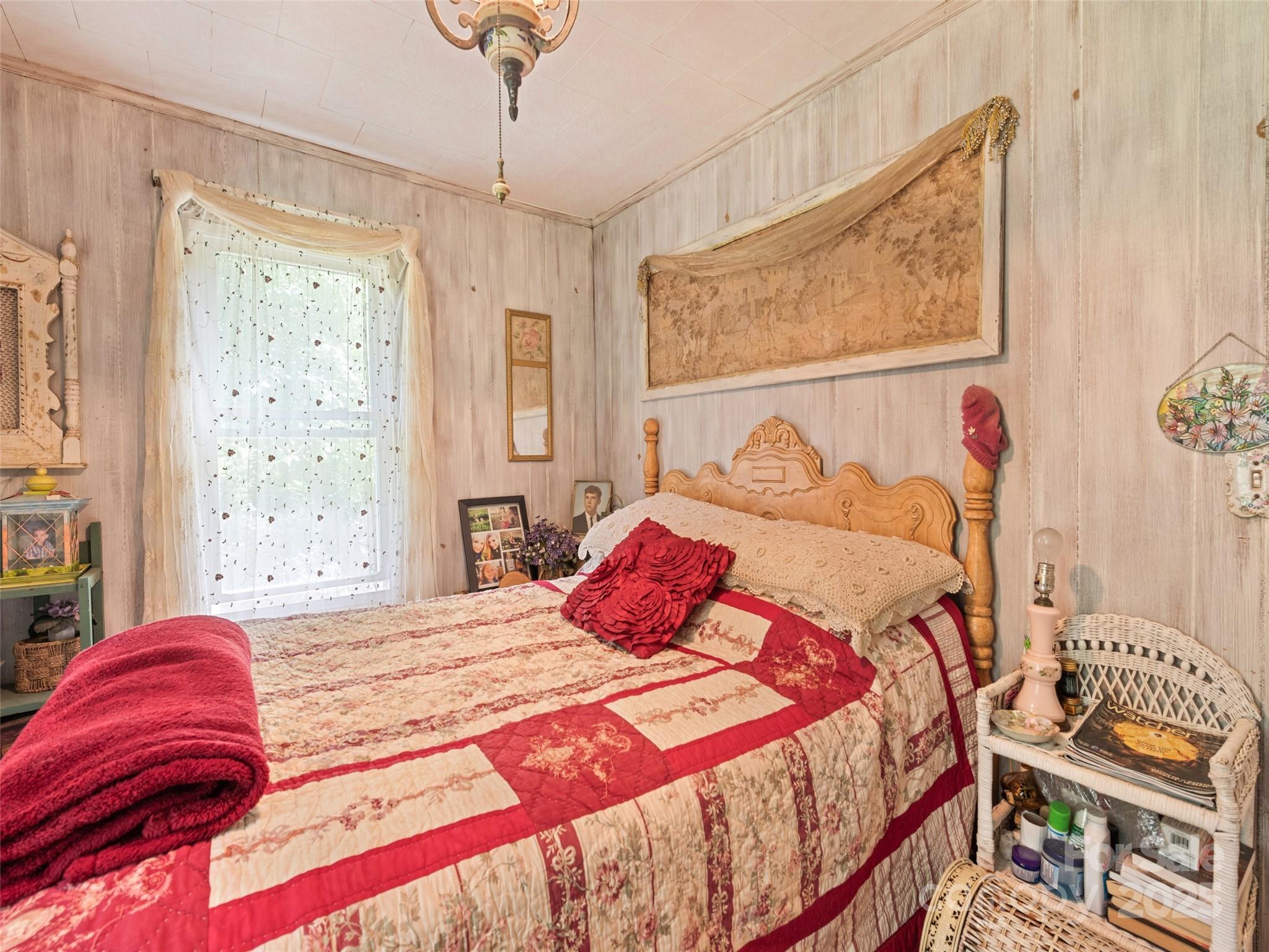 4828 Max Patch Road Clyde, NC 28721 - Photo 38 of 41 a bedroom with a bed and a painting on the wall