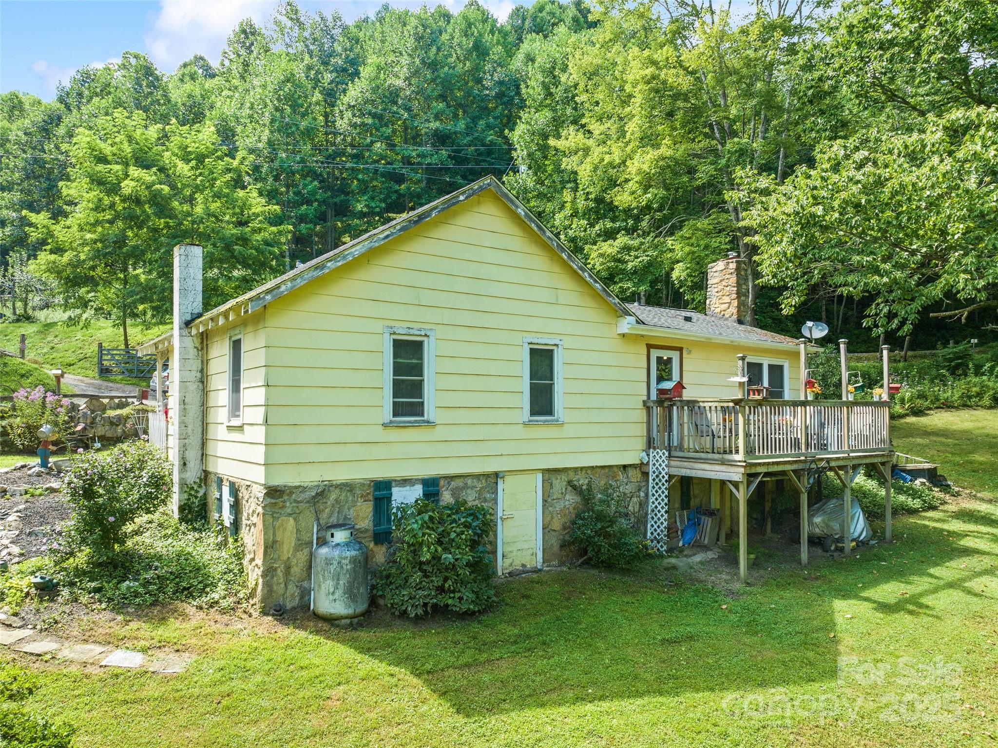 4828 Max Patch Road Clyde, NC 28721 - Photo 6 of 41 a backyard of a house with table and chairs