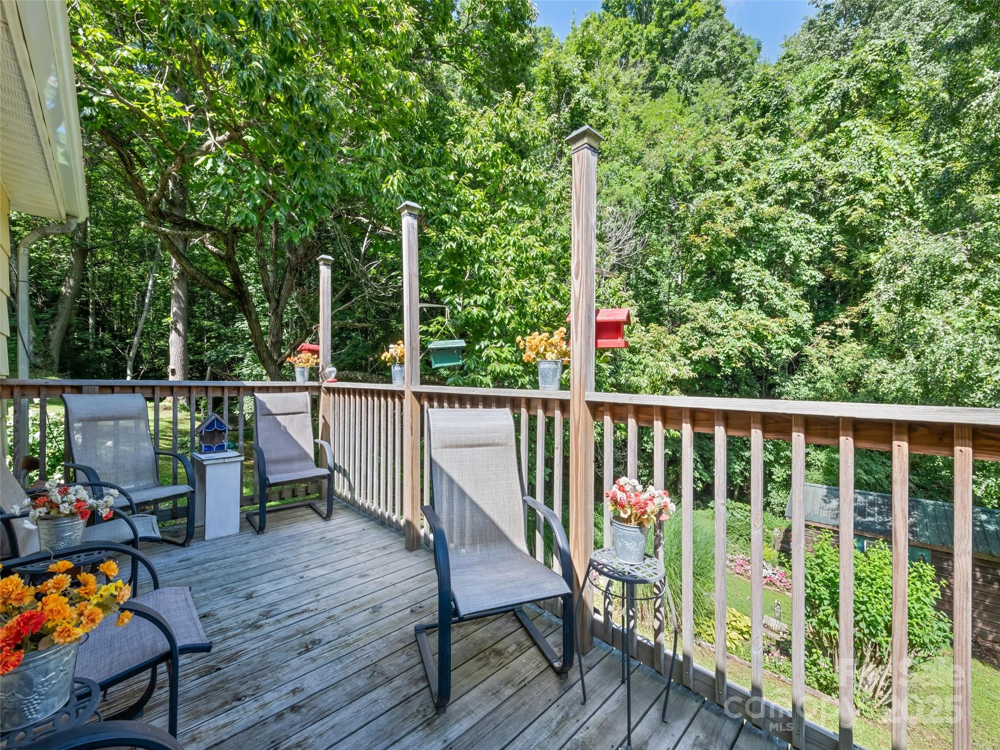 4828 Max Patch Road Clyde, NC 28721 - Photo 7 of 41 a view of a deck with two chair and wooden floor