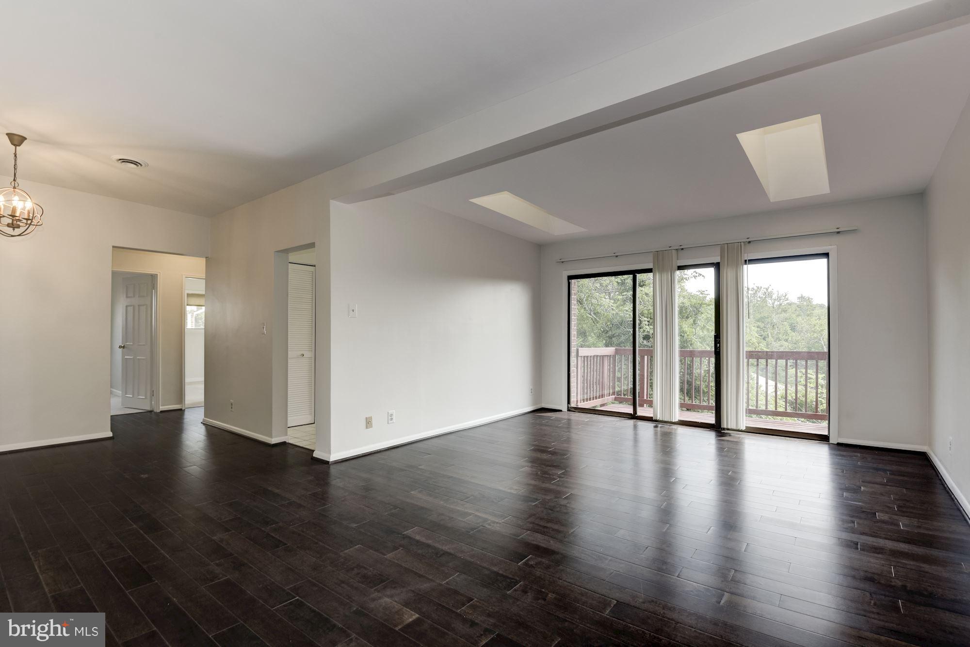 103 Skyhill Road, Unit 8 Alexandria, VA 22314 - Photo 3 of 26 Living Room with skylights & access to balcony.
