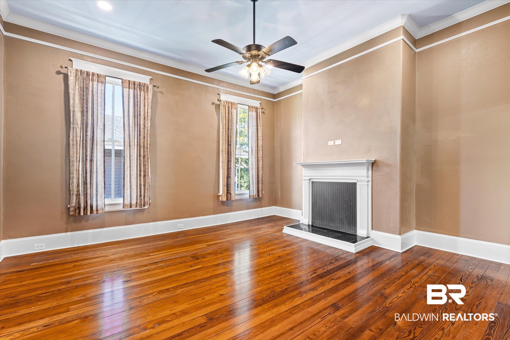 1310 Brown Street Mobile, AL 36604 - Photo 14 of 18 Unfurnished living room featuring ceiling fan, hardwood / wood-style flooring, and ornamental molding