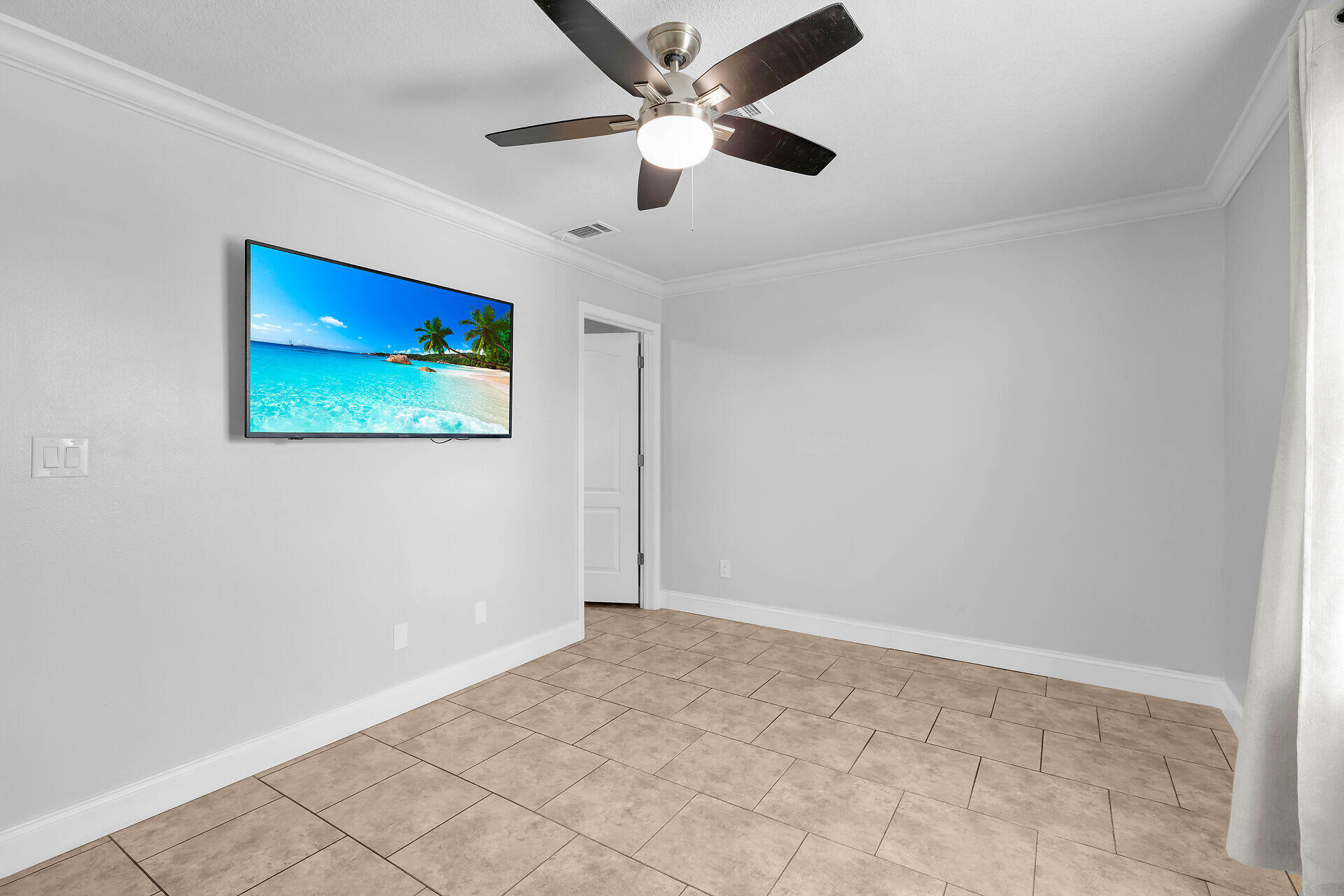 59 Ed Swift Road Key West, FL 33040 - Photo 20 of 35 an empty room with wooden floor and ceiling fan