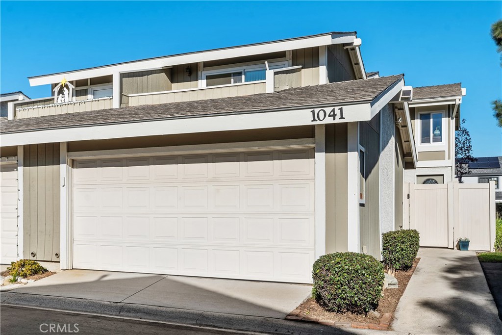 1041 Tustin Pines Way Tustin, CA 92780 - Photo 1 of 32 a front view of a house with garage