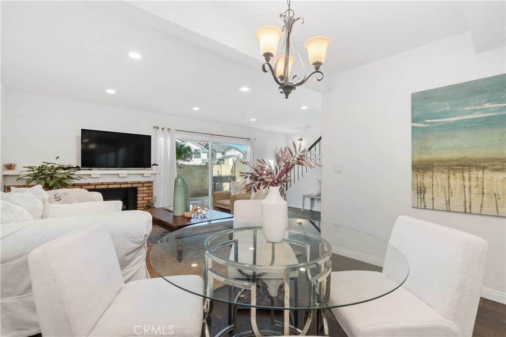 1041 Tustin Pines Way Tustin, CA 92780 - Photo 14 of 32 a living room with furniture a flat screen tv and kitchen view