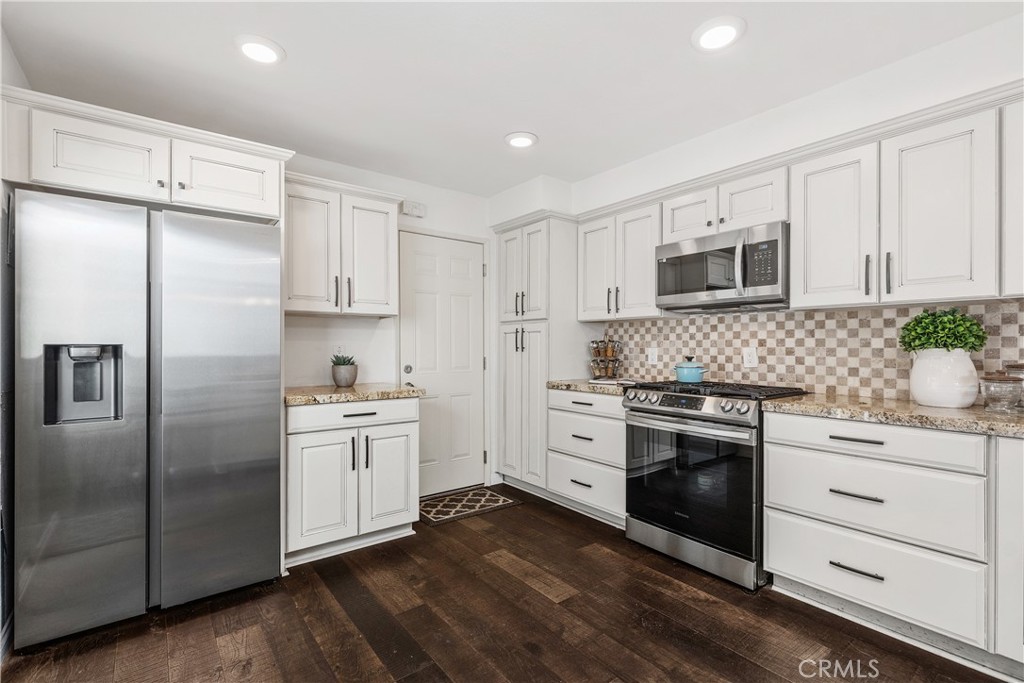 1041 Tustin Pines Way Tustin, CA 92780 - Photo 16 of 32 a kitchen with stainless steel appliances a stove sink and refrigerator