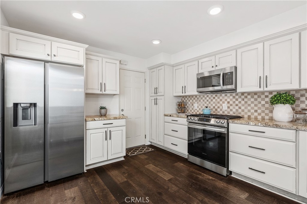 1041 Tustin Pines Way Tustin, CA 92780 - Photo 16 of 32 a kitchen with stainless steel appliances a stove sink and refrigerator
