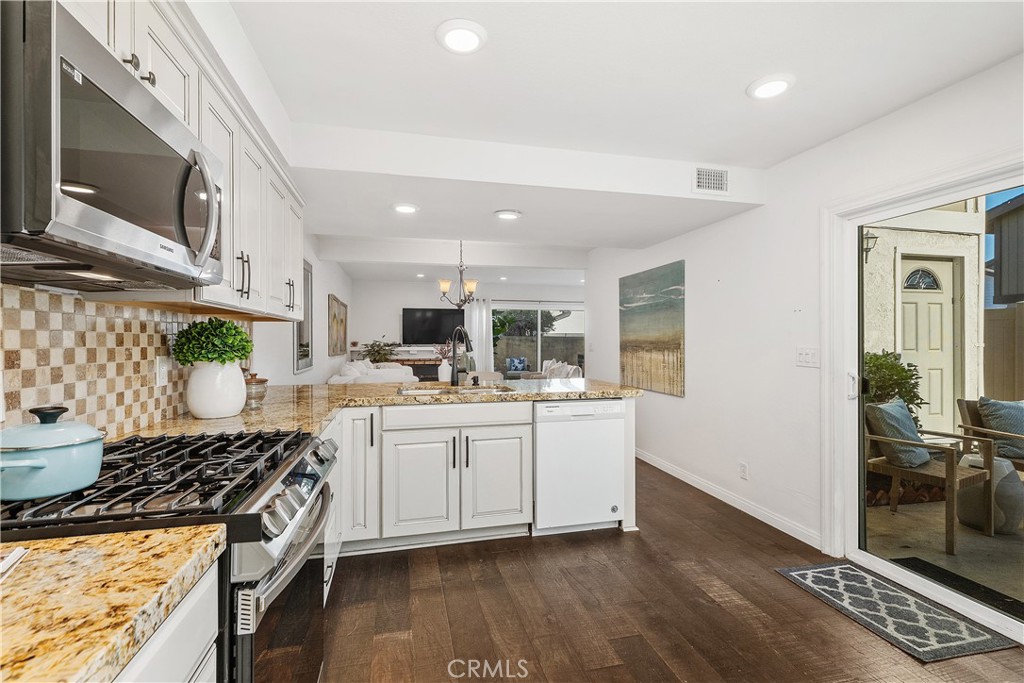 1041 Tustin Pines Way Tustin, CA 92780 - Photo 20 of 32 a kitchen with stainless steel appliances granite countertop a stove and a sink
