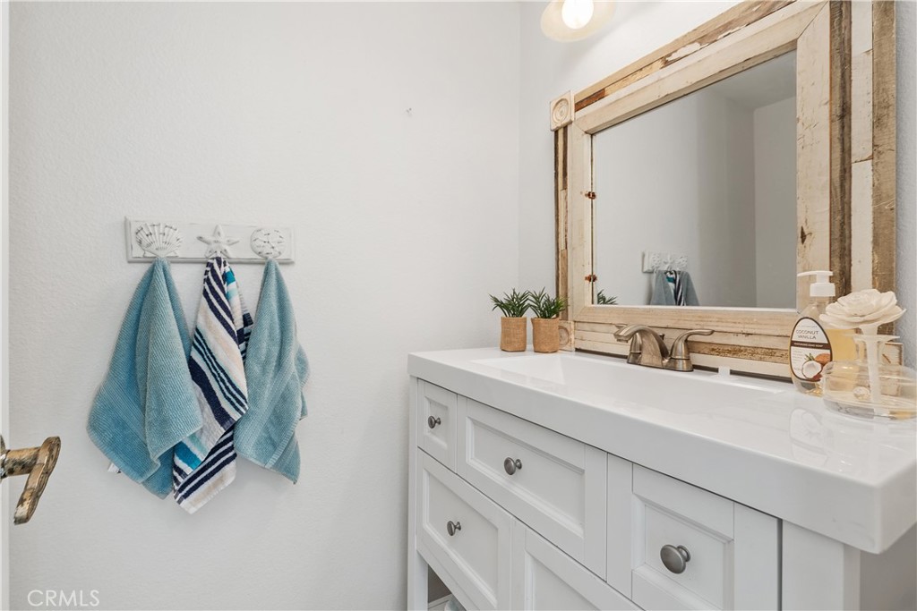 1041 Tustin Pines Way Tustin, CA 92780 - Photo 21 of 32 a bathroom with a sink and a mirror