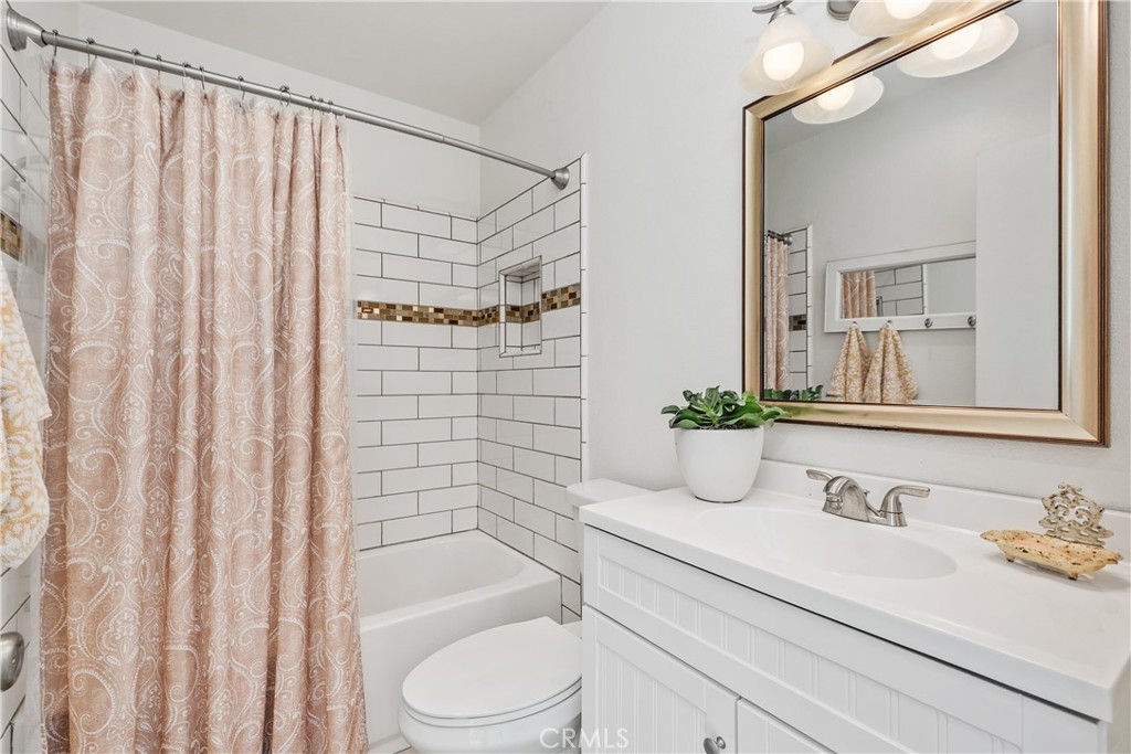 1041 Tustin Pines Way Tustin, CA 92780 - Photo 26 of 32 a bathroom with a granite countertop sink and a mirror