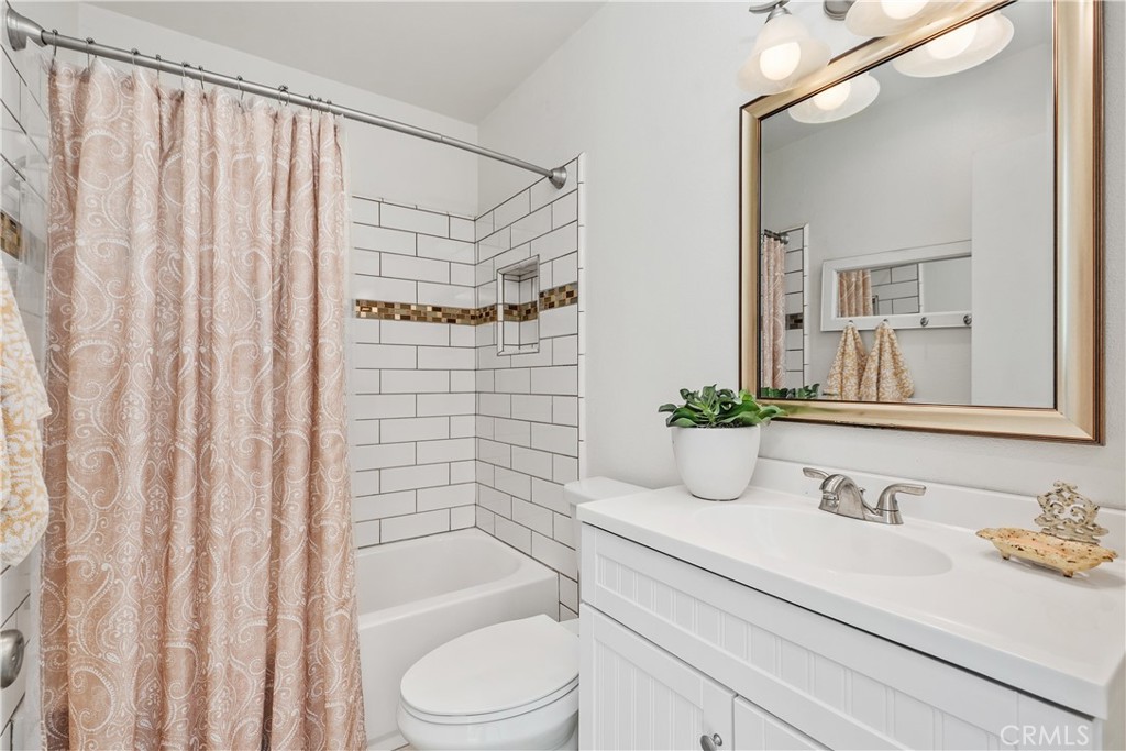 1041 Tustin Pines Way Tustin, CA 92780 - Photo 26 of 32 a bathroom with a granite countertop sink and a mirror
