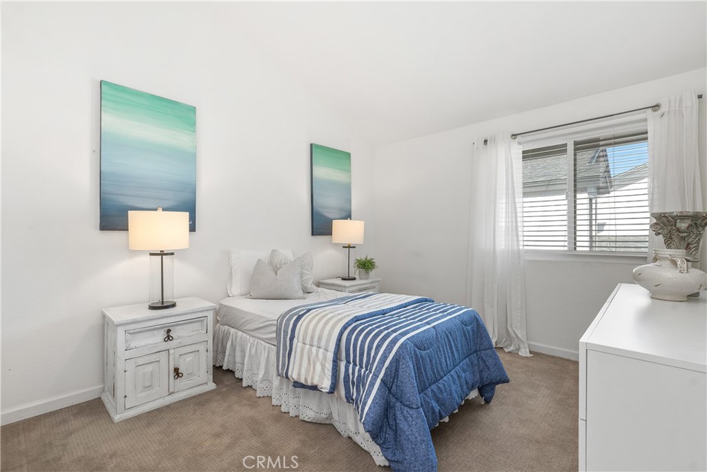1041 Tustin Pines Way Tustin, CA 92780 - Photo 27 of 32 a bedroom with a bed and a night stand