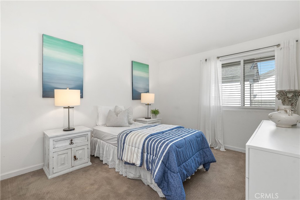 1041 Tustin Pines Way Tustin, CA 92780 - Photo 27 of 32 a bedroom with a bed and a night stand