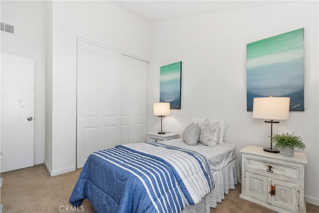 1041 Tustin Pines Way Tustin, CA 92780 - Photo 28 of 32 a bedroom with a bed and a lamp on dresser
