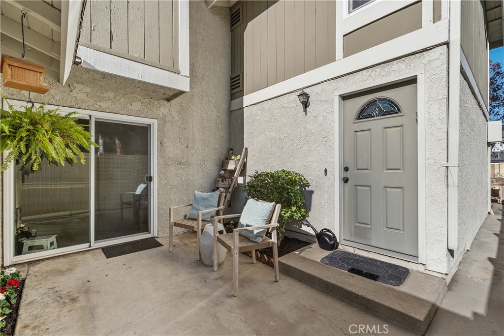 1041 Tustin Pines Way Tustin, CA 92780 - Photo 3 of 32 a view of a porch with furniture and front door
