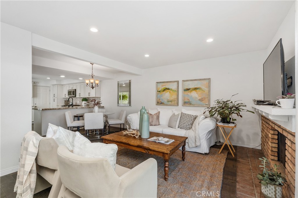 1041 Tustin Pines Way Tustin, CA 92780 - Photo 6 of 32 a living room with furniture a flat screen tv and kitchen view